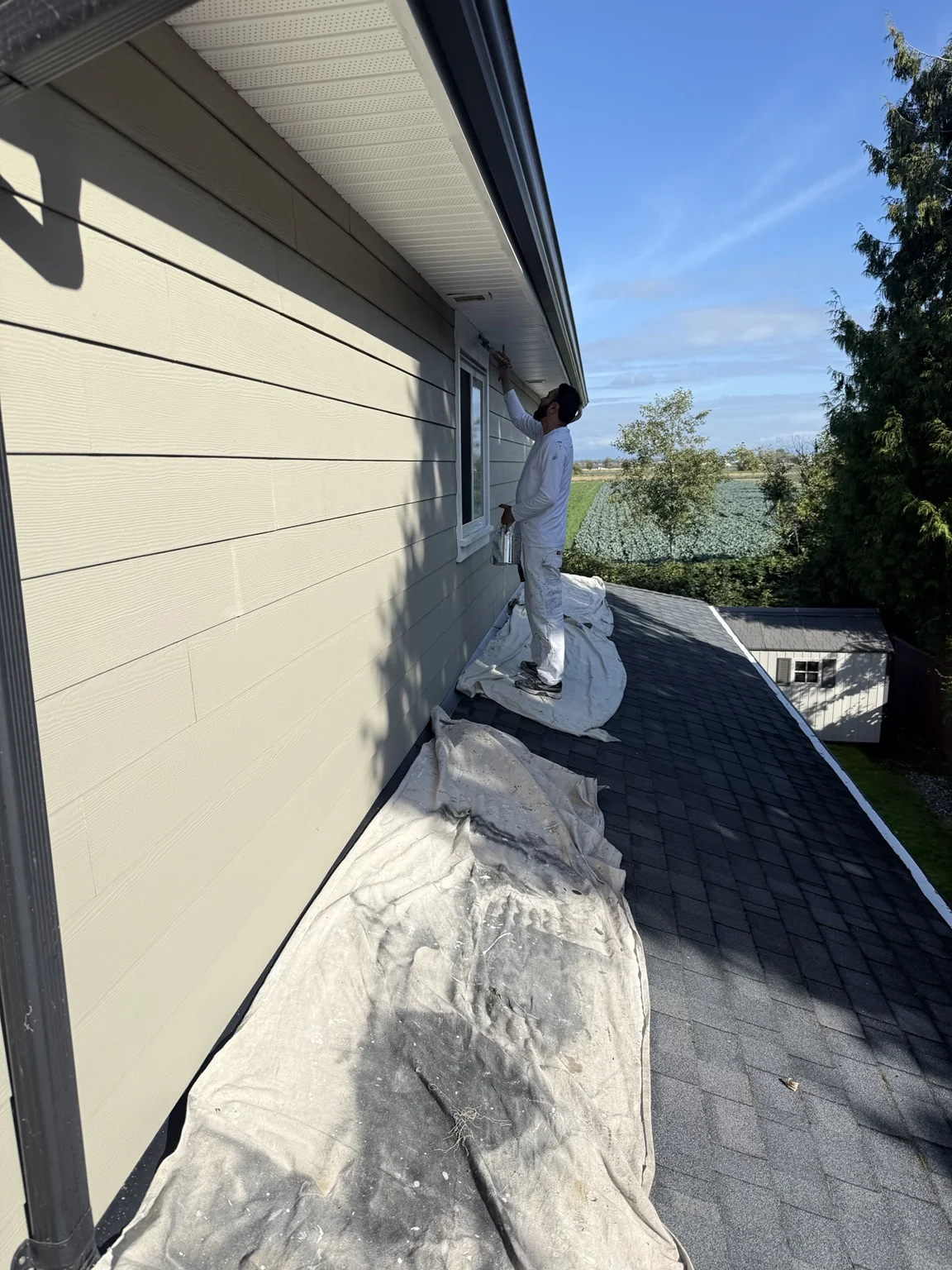 Painter working on exterior trim
